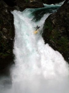Jeremy Moran a guide with Montana River Guides, kayaking off a waterfall